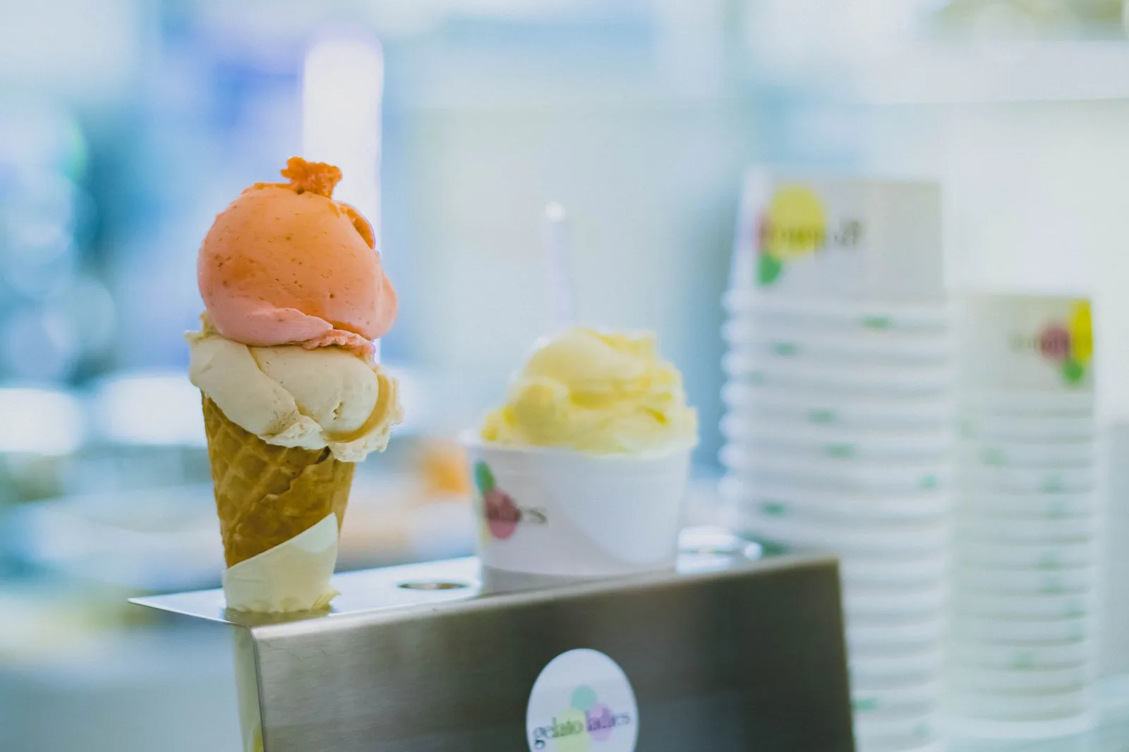 Scoops of creamy ice cream in a cone at an ice cream shop