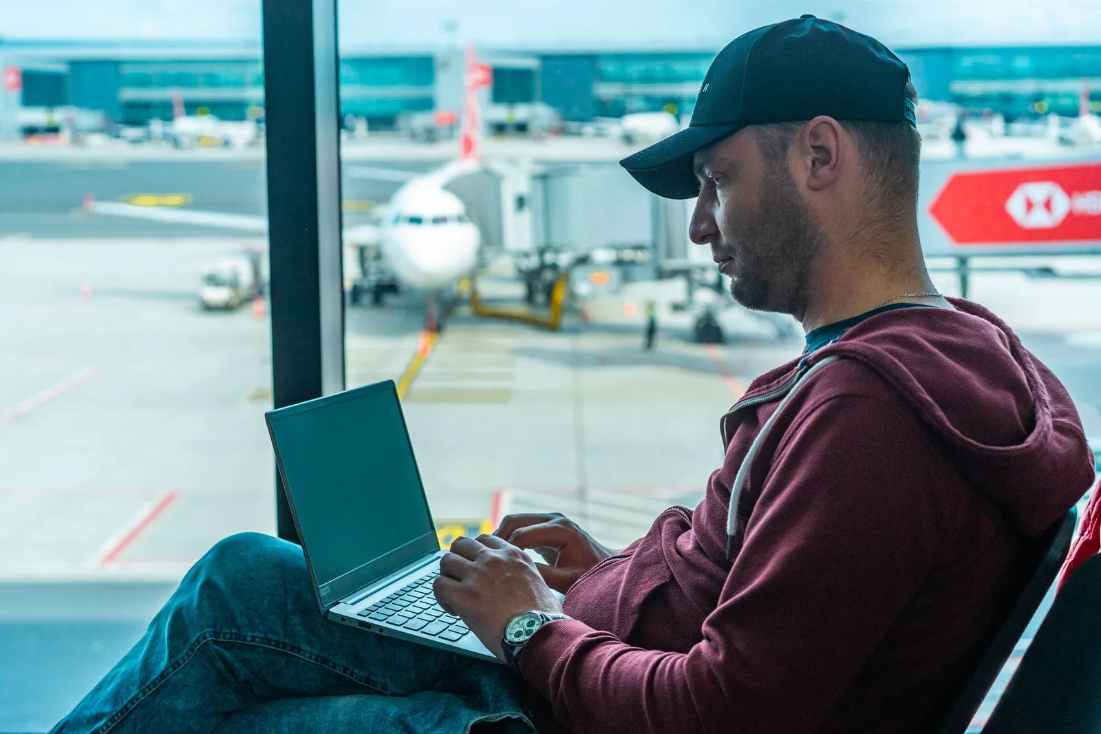 A traveller sorting a claim on a laptop at the airport