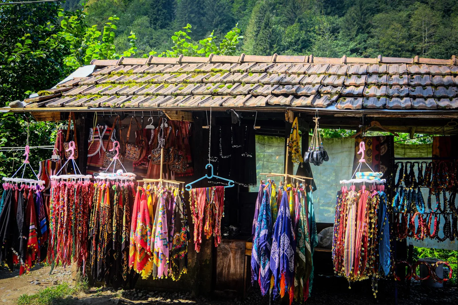 Colourful textiles and crafts on an outdoor market stall