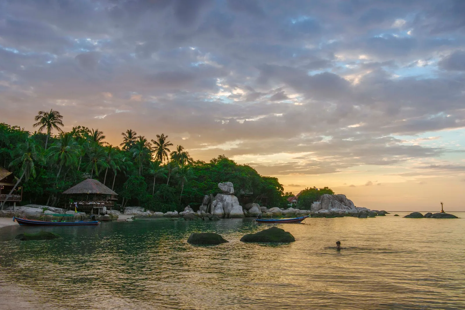 Rock-framed bay at sunset on Koh Tao