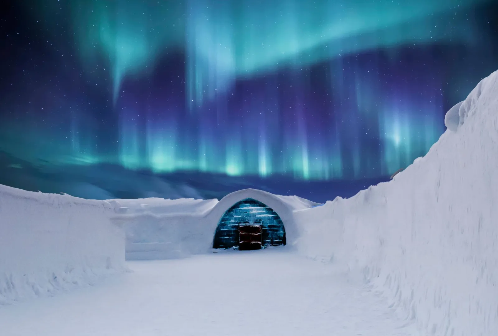 A glass igloo under the Northern Lights